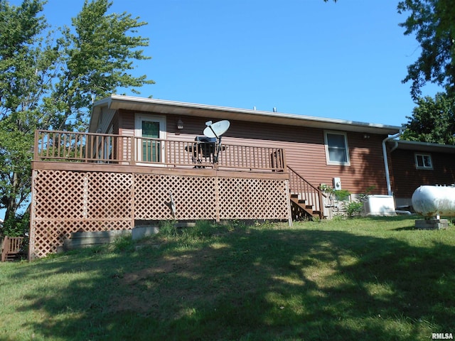 rear view of property featuring a lawn and a wooden deck