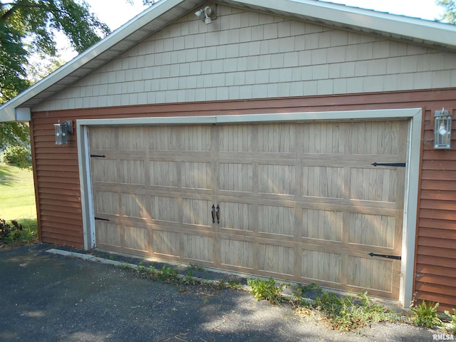 garage featuring wood walls