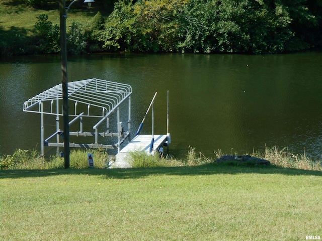 dock area featuring a water view and a lawn