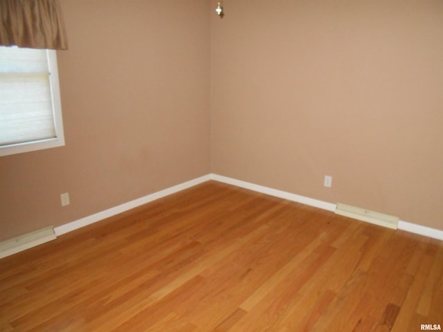 unfurnished room featuring hardwood / wood-style floors