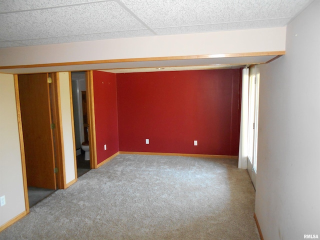 interior space with light carpet and a drop ceiling