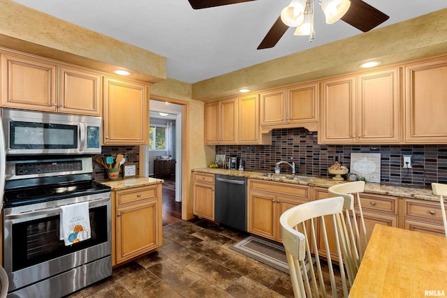 kitchen featuring ceiling fan, decorative backsplash, stainless steel appliances, light brown cabinets, and sink