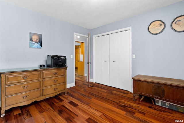 bedroom featuring dark wood-type flooring and a closet