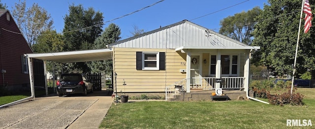 bungalow-style house with a front yard, covered porch, and a carport