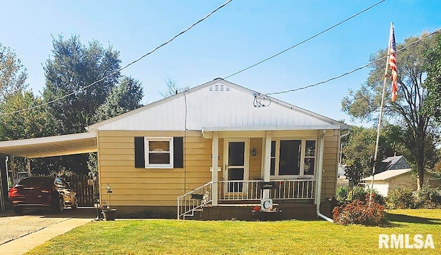 bungalow-style home with a carport, a porch, and a front yard