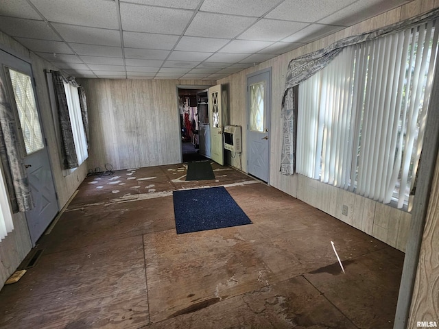 foyer entrance with heating unit and a paneled ceiling