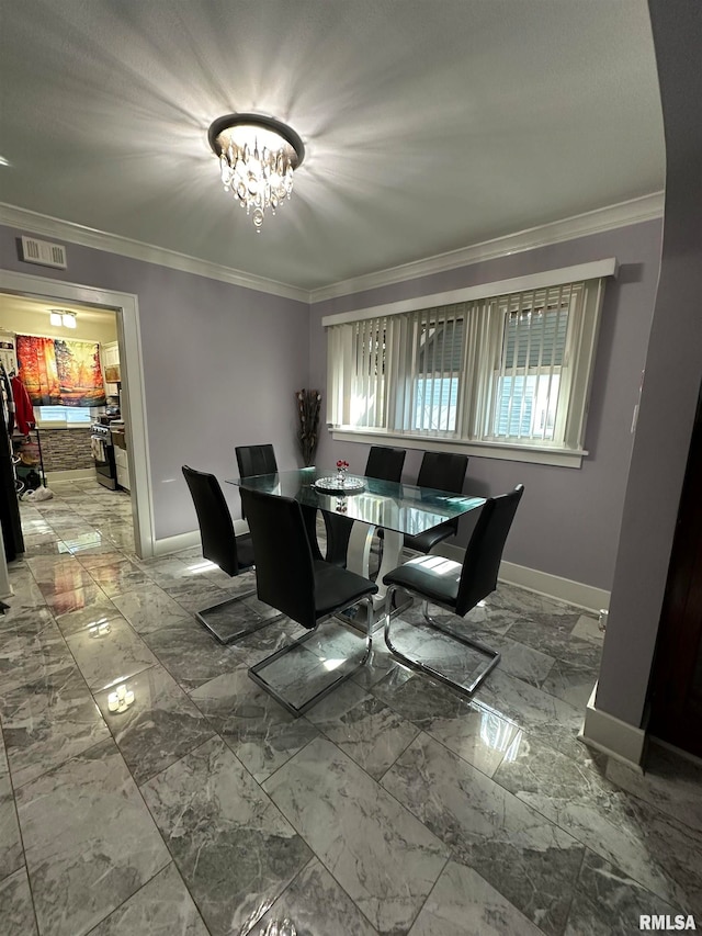 dining space with ornamental molding and an inviting chandelier