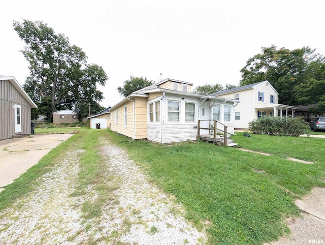 rear view of property featuring a yard