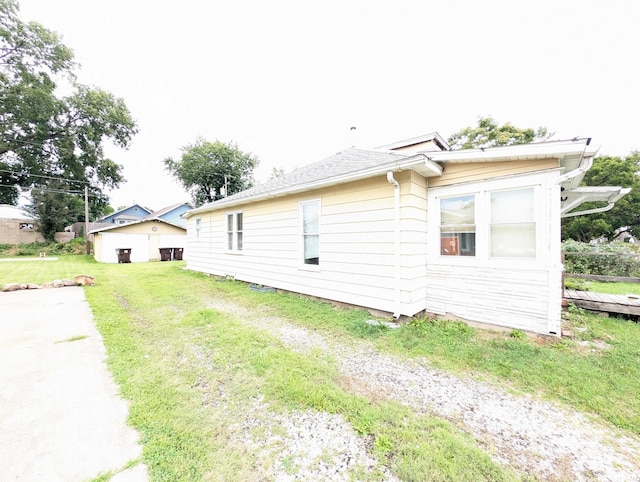 view of side of home with a yard