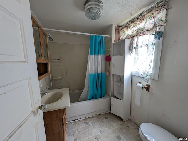 full bathroom with a textured ceiling, vanity, toilet, and shower / bath combo with shower curtain