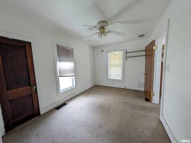 unfurnished bedroom with ceiling fan and light colored carpet