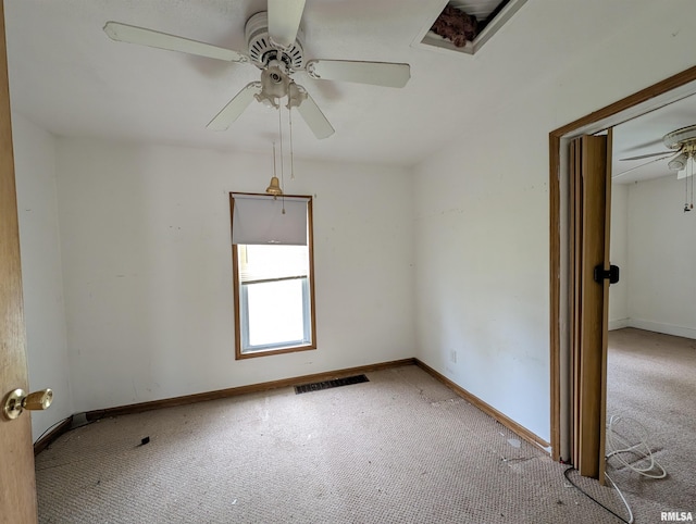 spare room featuring light carpet and ceiling fan