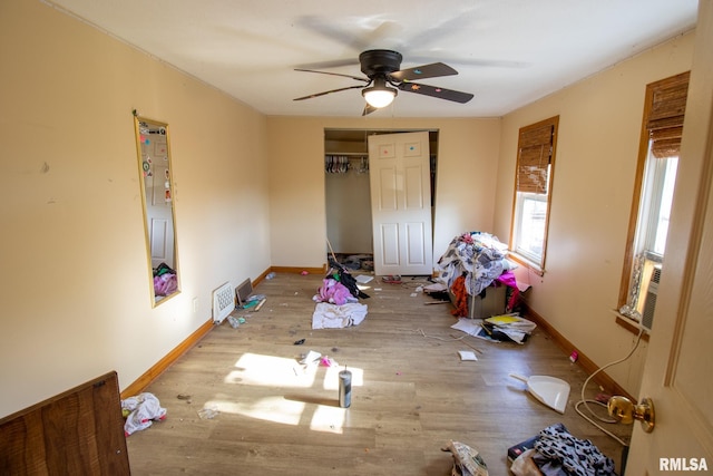 bedroom featuring ceiling fan, a closet, and light hardwood / wood-style floors