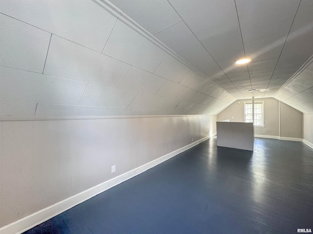 additional living space with lofted ceiling and dark hardwood / wood-style flooring