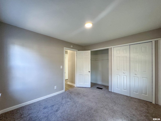 unfurnished bedroom with carpet floors and a closet