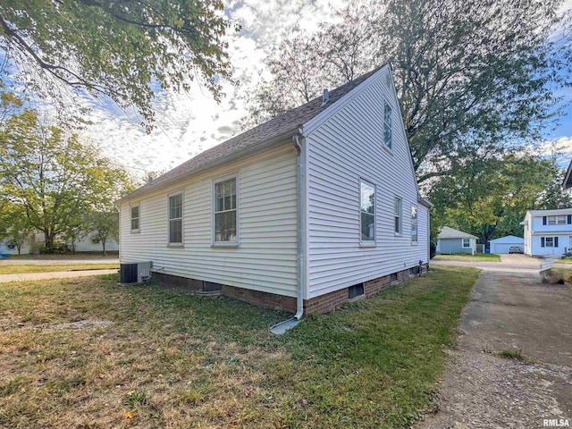 view of home's exterior featuring a yard and central AC