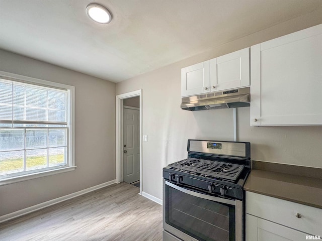 kitchen with stainless steel range with gas cooktop, light wood-type flooring, and white cabinets