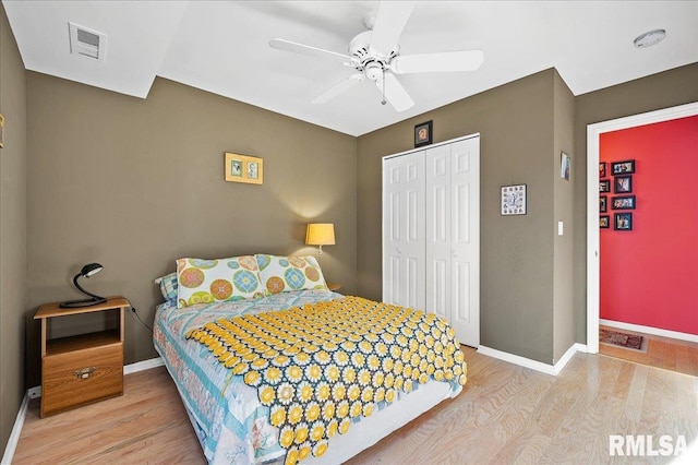 bedroom featuring ceiling fan, a closet, and light hardwood / wood-style flooring