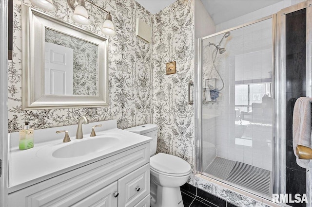 bathroom featuring walk in shower, tile patterned flooring, vanity, and toilet