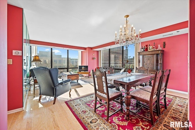 dining room featuring wood-type flooring and a notable chandelier