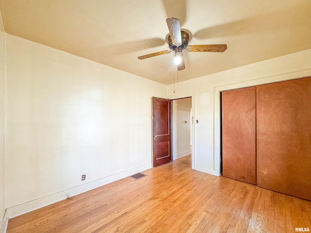 unfurnished bedroom with ceiling fan, a closet, and light hardwood / wood-style flooring