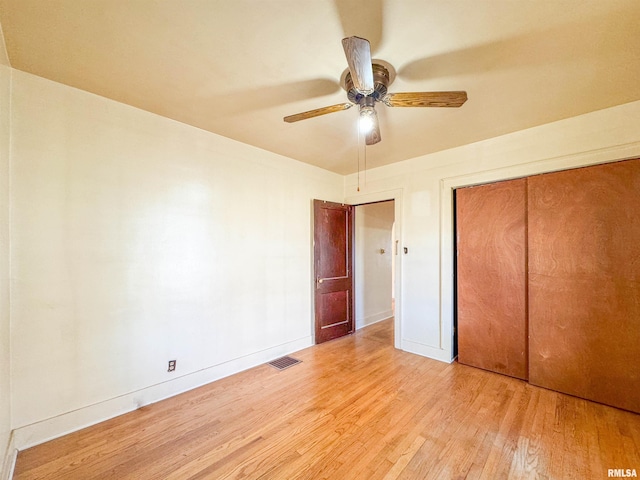 782 N Ave B, Canton, IL 61520 - unfurnished bedroom with wood finished floors, baseboards, a closet, and ceiling fan