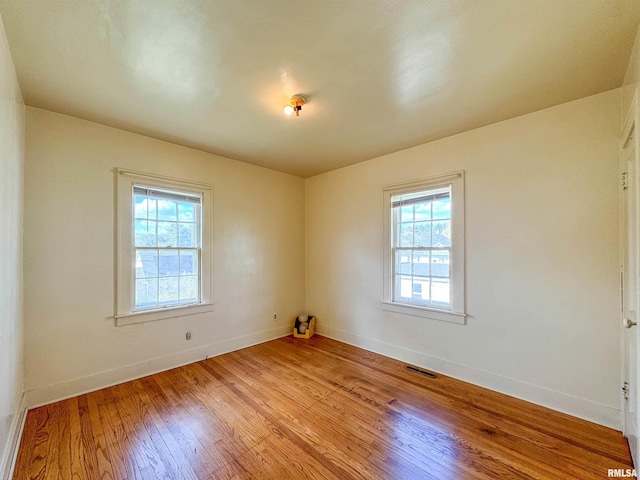 782 N Ave B, Canton, IL 61520 - empty room with healthy amount of natural light, light wood finished floors, and baseboards