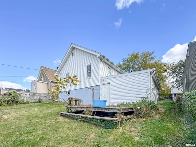 rear view of property with a lawn