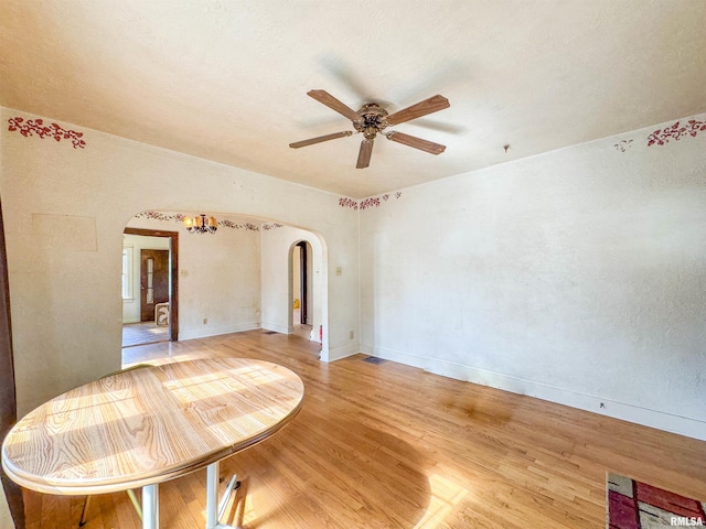 782 N Ave B, Canton, IL 61520 - empty room with arched walkways, a ceiling fan, light wood-type flooring, and baseboards