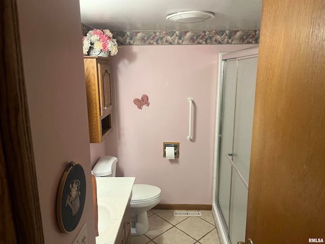 bathroom featuring toilet, vanity, tile patterned floors, and walk in shower