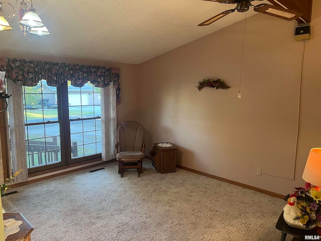 unfurnished room featuring a textured ceiling, light colored carpet, ceiling fan, and lofted ceiling