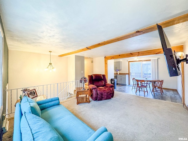 living room with carpet and a notable chandelier