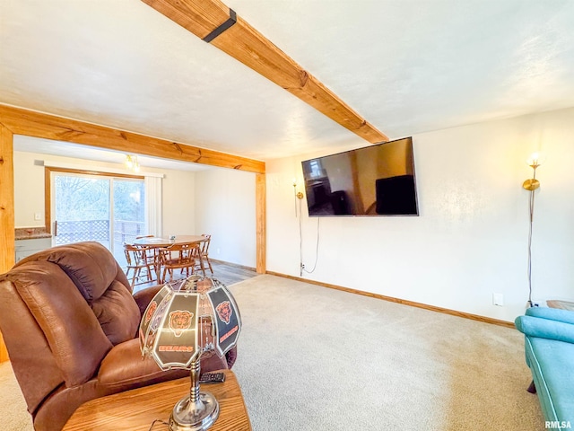 living room with beam ceiling and carpet