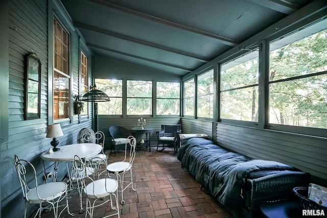 sunroom / solarium with lofted ceiling with beams