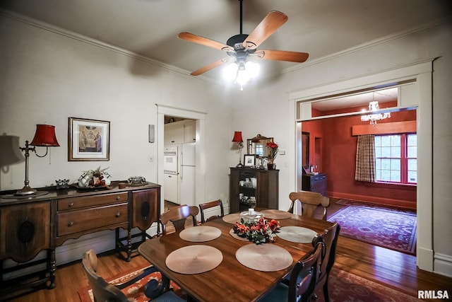 dining area featuring ornamental molding and dark wood-type flooring