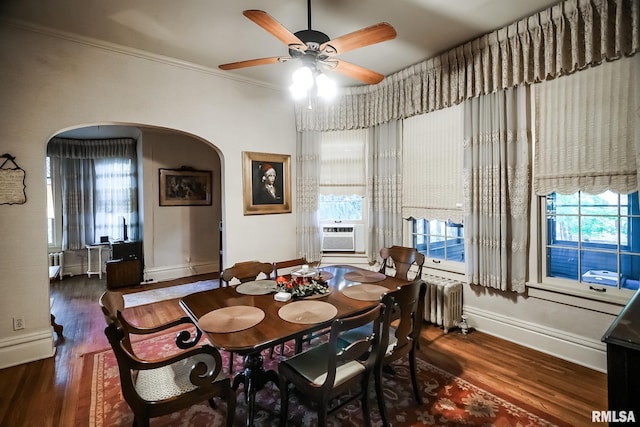 dining room featuring cooling unit, dark hardwood / wood-style flooring, radiator heating unit, ceiling fan, and ornamental molding