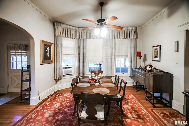 dining area featuring ornamental molding, a healthy amount of sunlight, ceiling fan, and dark hardwood / wood-style flooring