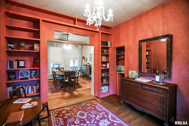 office area featuring a chandelier, wood-type flooring, and built in features