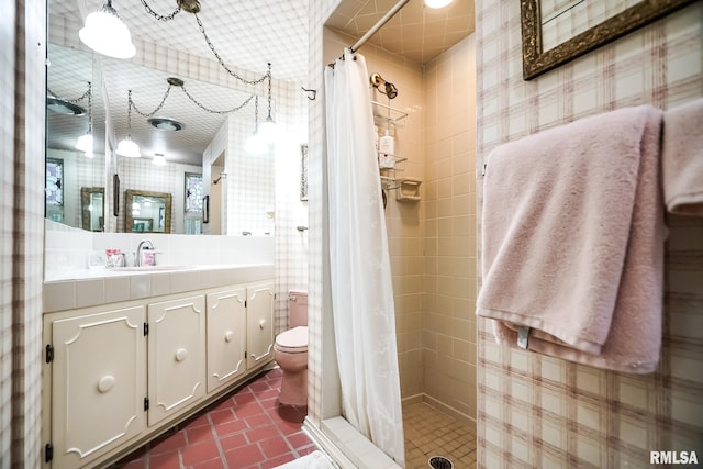 bathroom featuring vanity, toilet, and walk in shower