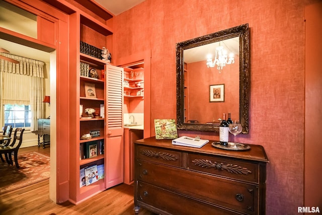 interior space featuring light hardwood / wood-style floors, an inviting chandelier, and sink