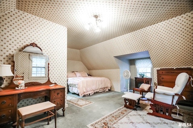 bedroom featuring light carpet, multiple windows, a notable chandelier, and lofted ceiling