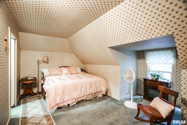 bedroom featuring lofted ceiling and carpet flooring