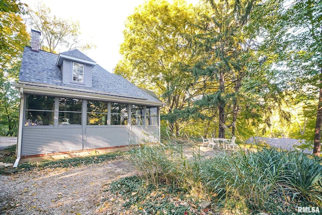 view of side of home with a sunroom