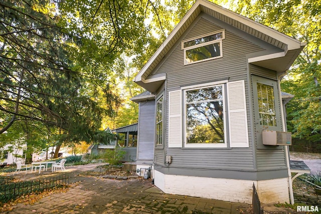 view of property exterior with a patio area