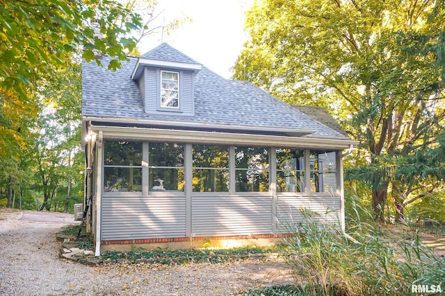 view of property exterior featuring a sunroom