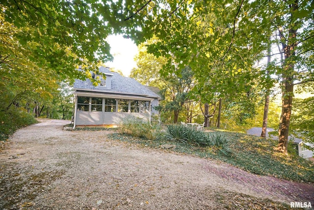 view of side of home with a sunroom