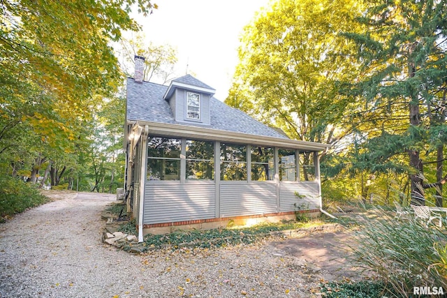 view of side of property featuring a sunroom