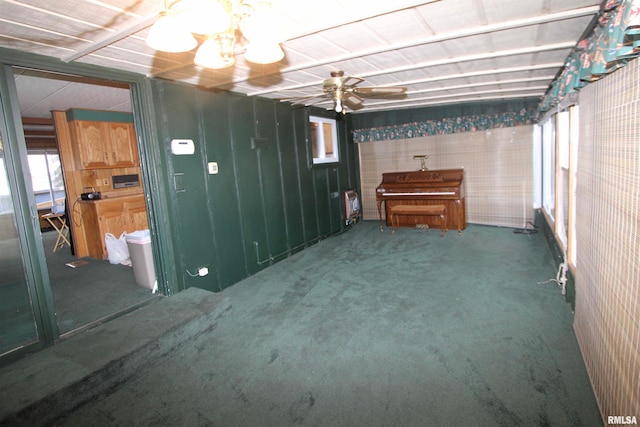 basement featuring heating unit, carpet flooring, and ceiling fan