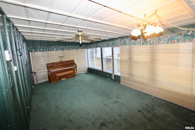 unfurnished sunroom featuring ceiling fan with notable chandelier