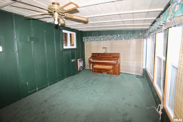 misc room featuring heating unit, ceiling fan, and carpet floors